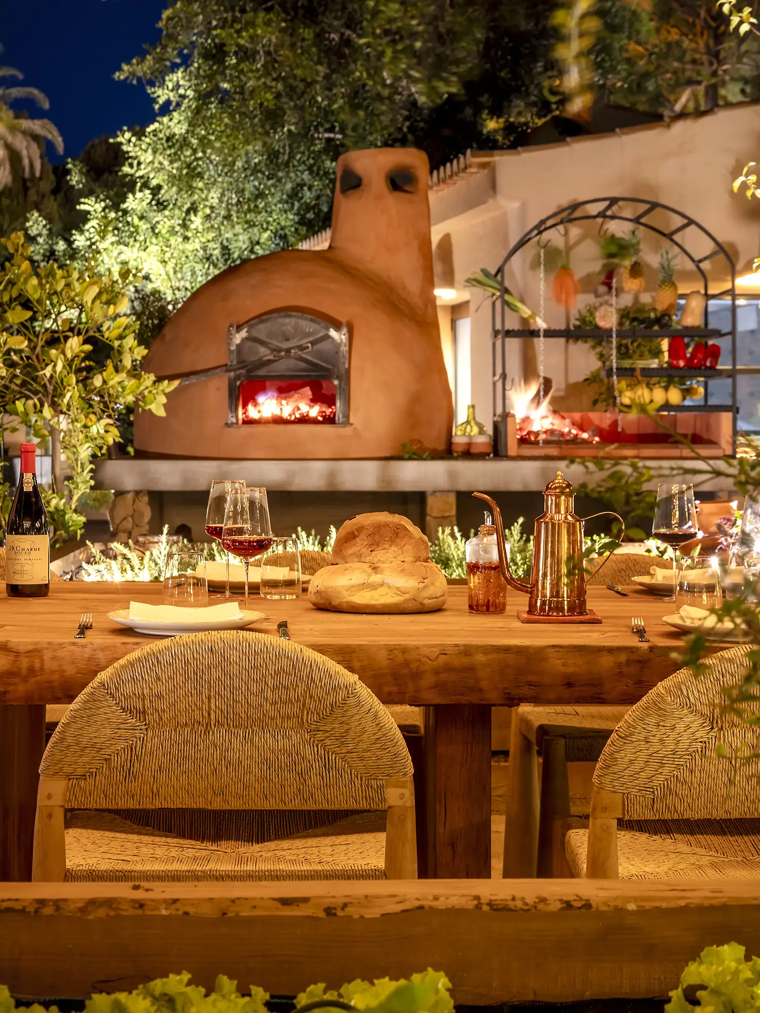 Oven and table at night at Raízes, Horta da Terra