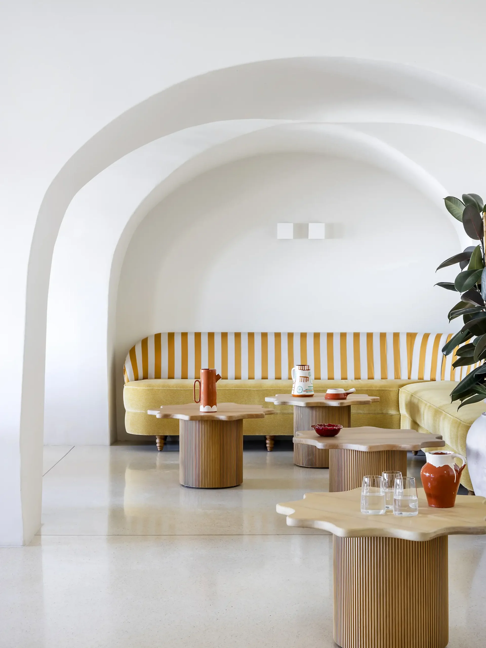 Striped banquette under arch at A Costa Restaurant