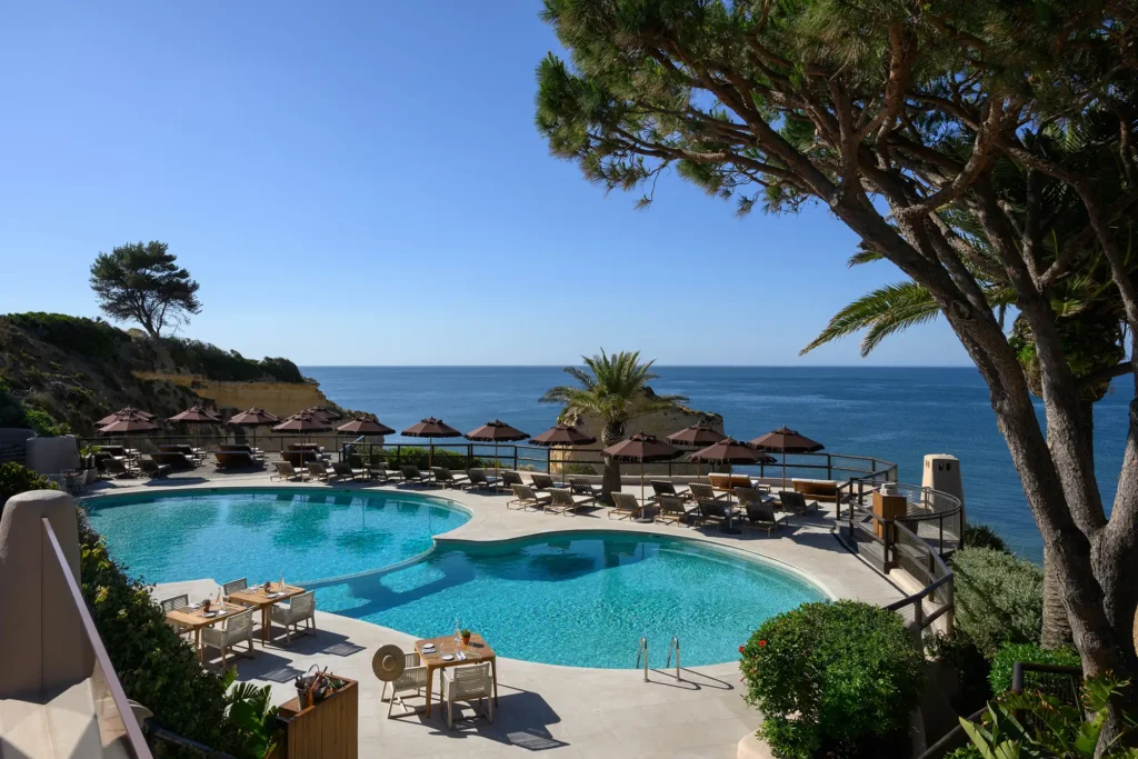 Vilalara cliffside pools and parasols overlooking the Atlantic through umbrella pines