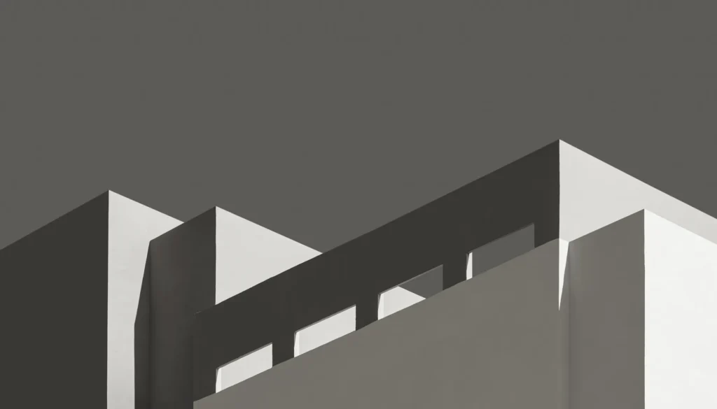 Abstract black and white architecture: white geometric volumes against a grey sky