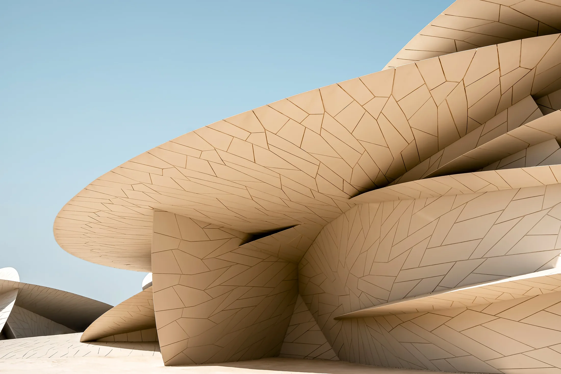 Interlocking disc forms of the National Museum of Qatar in Doha against a clear sky