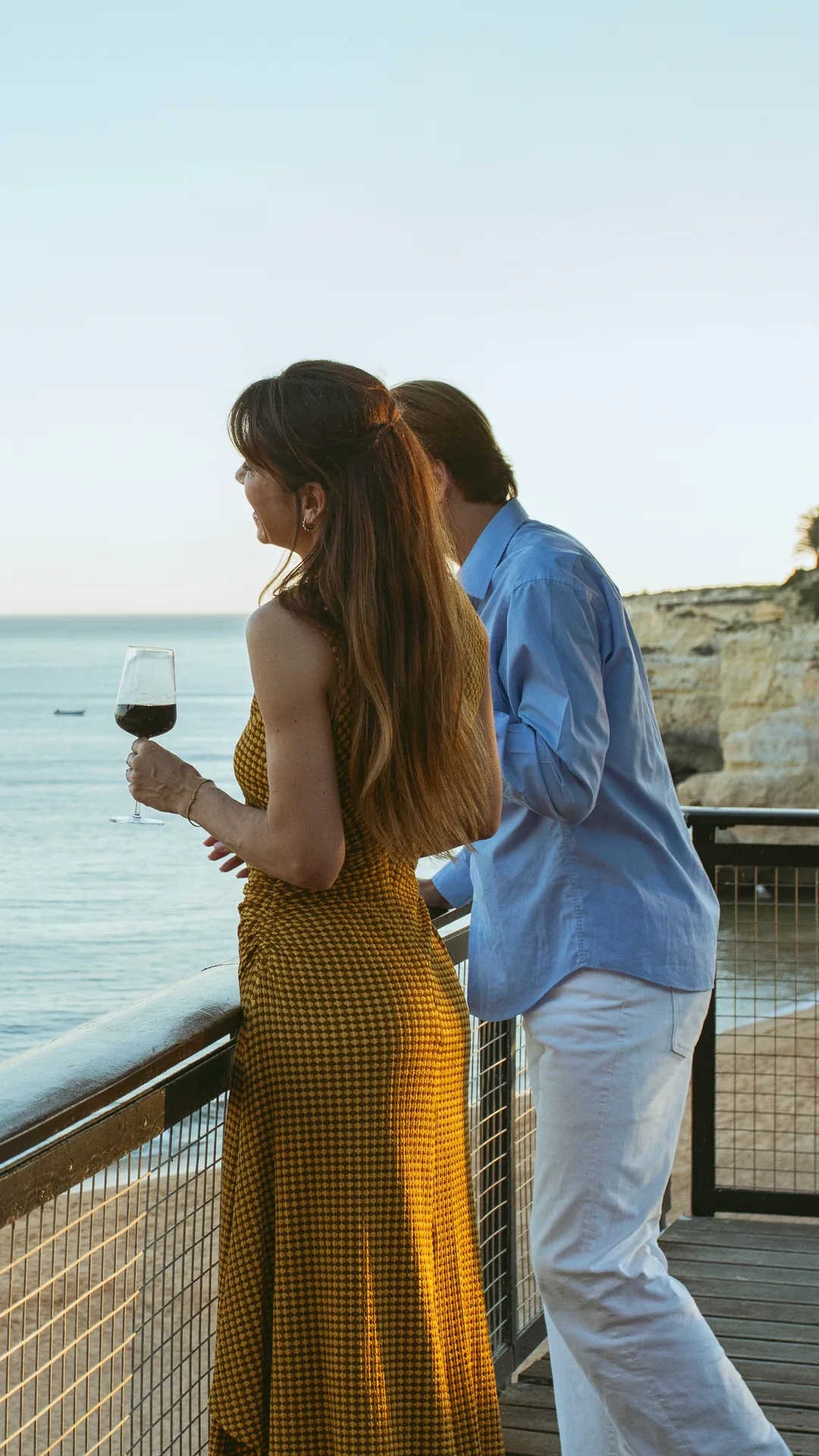 Couple with wine on the balcony at A Costa Restaurant