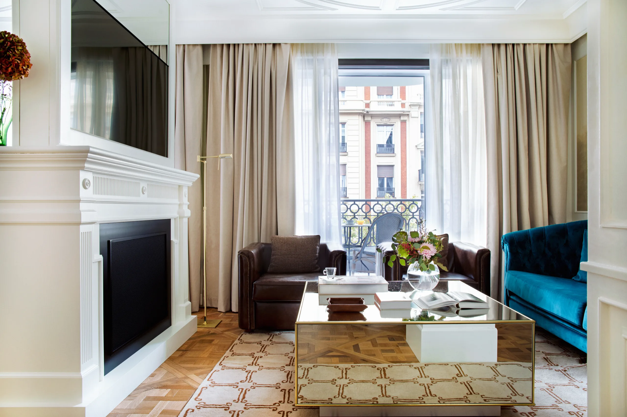 Living room with fireplace and blue sofa, BLESS Madrid