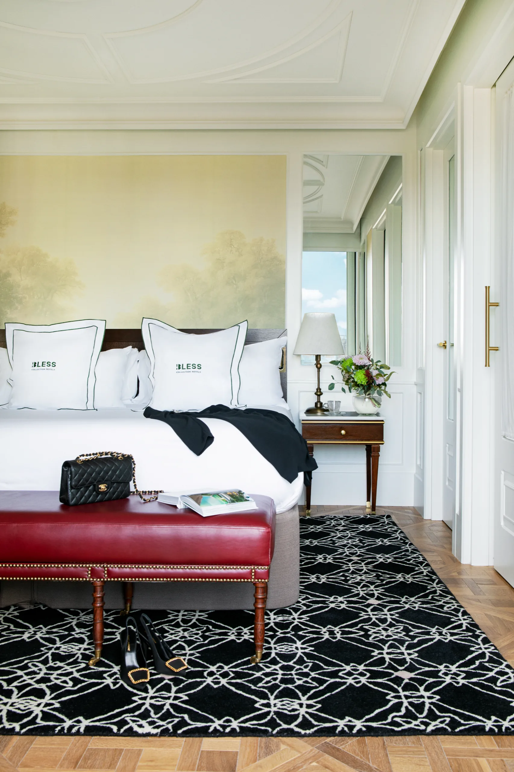 Bedroom with red bench and patterned rug, BLESS Madrid