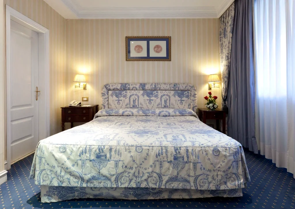 Old-style bedroom with floral bedspread, BLESS Madrid