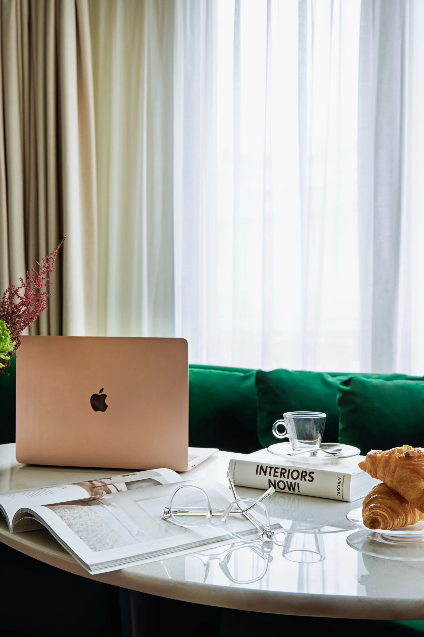 Desk with laptop, green sofa, BLESS Madrid