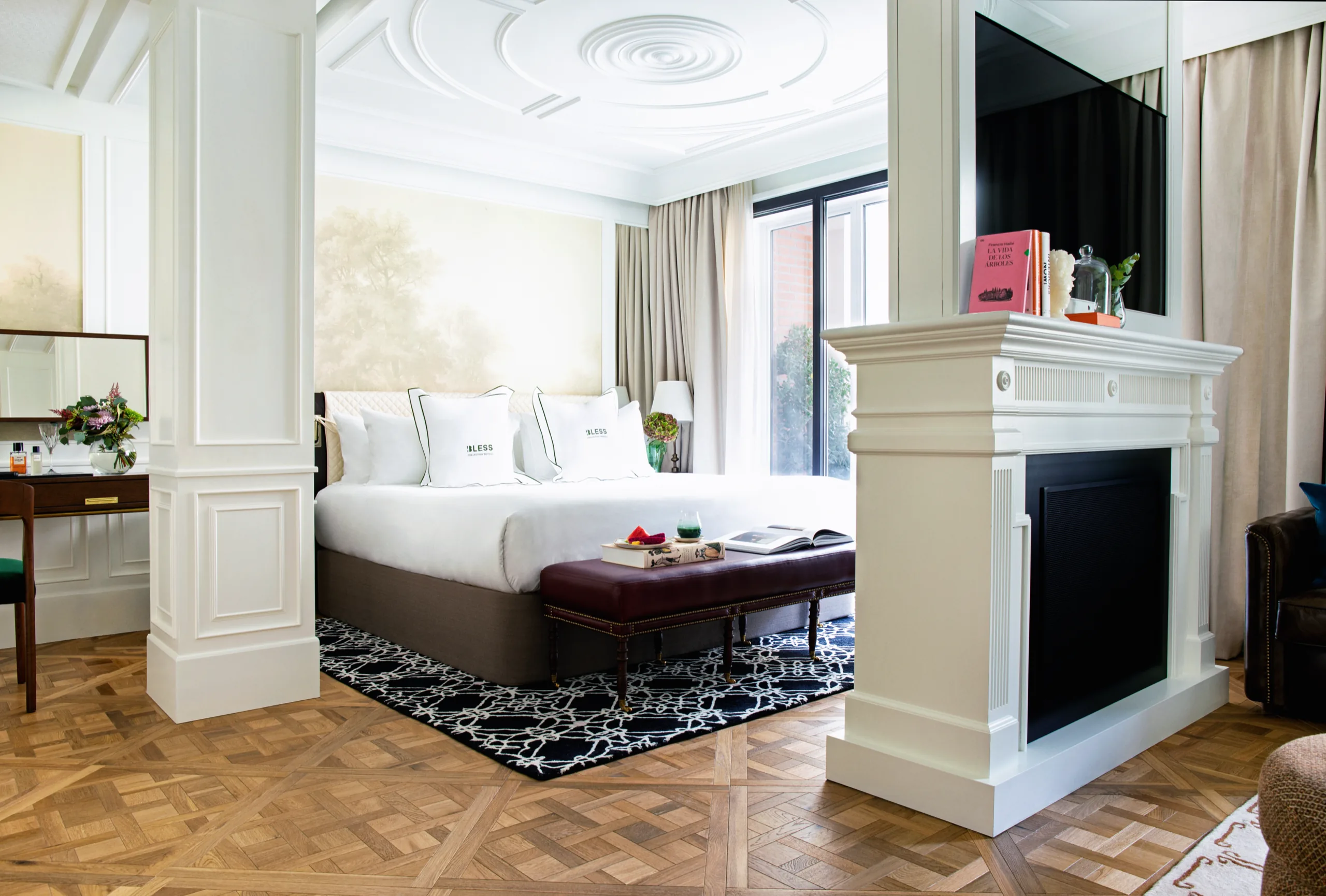 Bedroom with white fireplace and patterned rug, BLESS Madrid