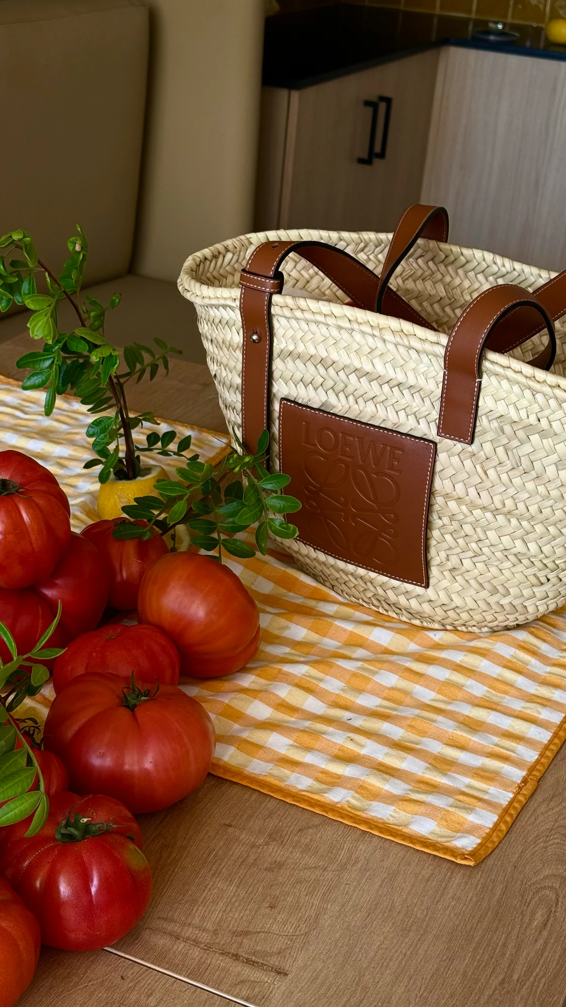 PSC-Trattoria-p52-0 · Permanent State of Creation Straw basket and tomatoes on checked cloth at Trattoria Pantaleone