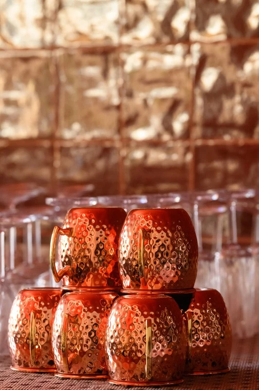 Stacked copper mugs at Vento Restaurant