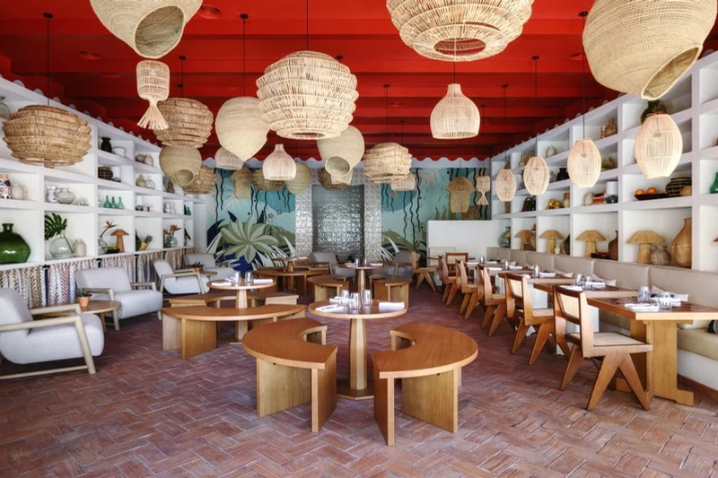 Dining room with wicker lamps, wide view at Vento Restaurant